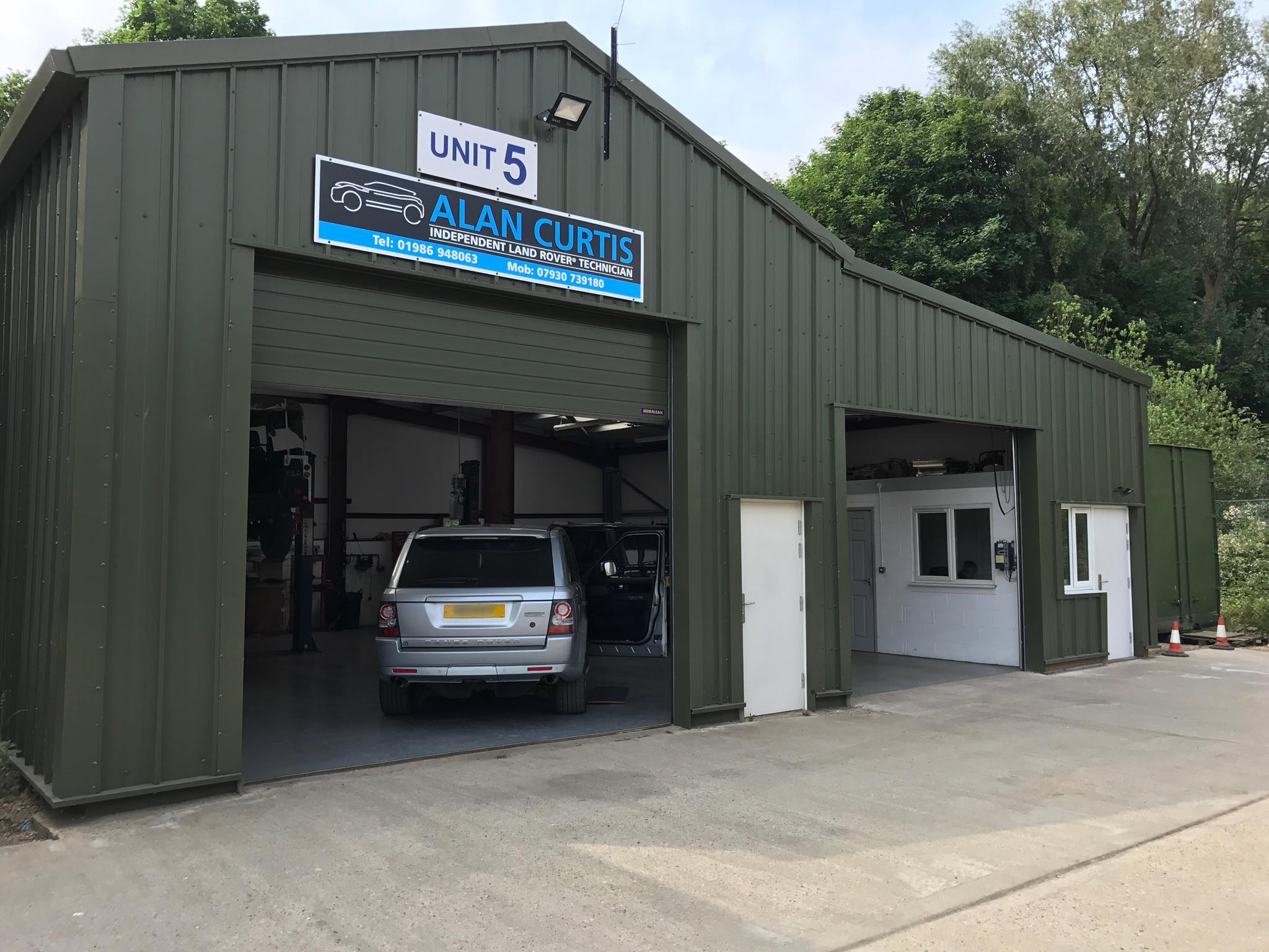Exterior view of Alan Curtis Land Rover Specialist mechanic shop. Inside is a silver range rover.